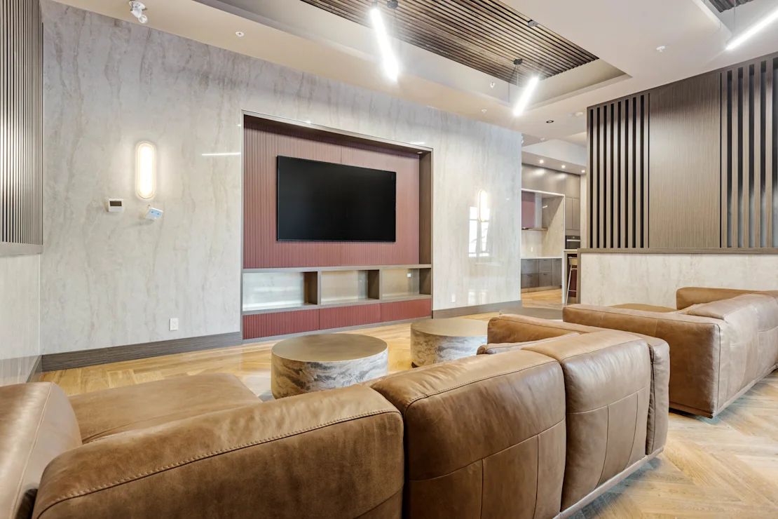 Clubhouse lounge with leather sofas and a large television