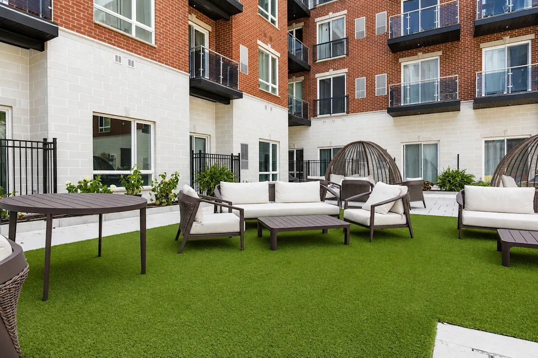 Courtyard patio with lounge furniture against the brick facade
