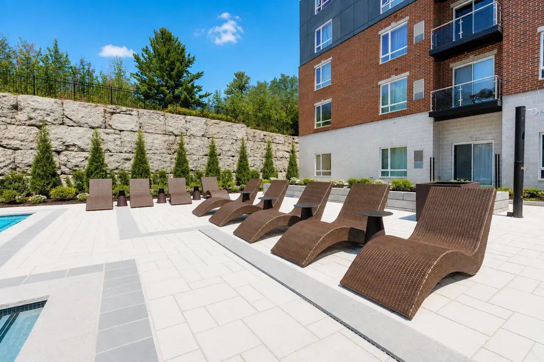 A row of lounge chairs beside the pool
