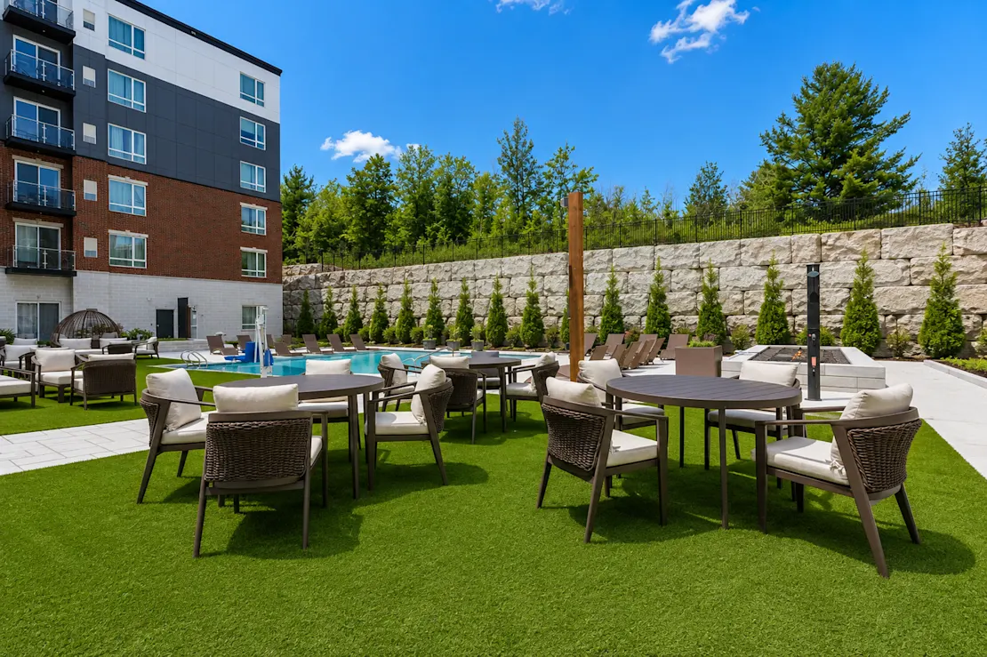 Terrace dining tables set against the stone retaining wall